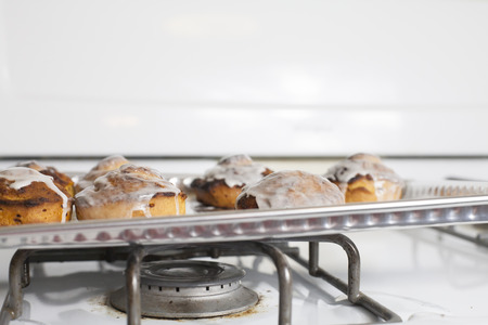 Fresh, iced cinnamon rolls on a baking sheet