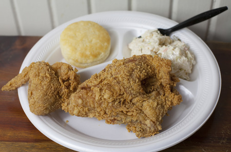 Fried chicken meal with coleslaw and a biscuitの写真素材