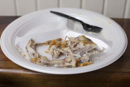 Chicken bones left on a plate after a mealの写真素材