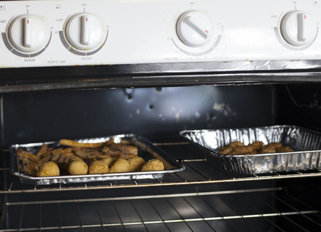 Hush puppies and French fries baking in the oven