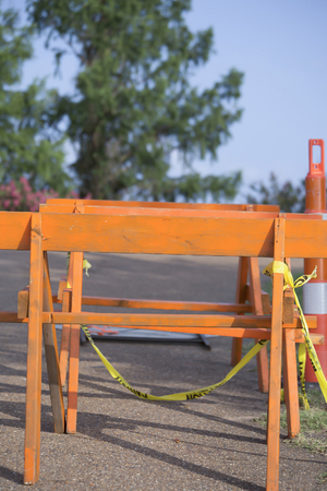 An orange road sign and cone blocking trafficの写真素材