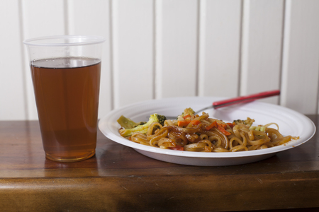 Chinese noodles meal with a glass of sweet teaの写真素材