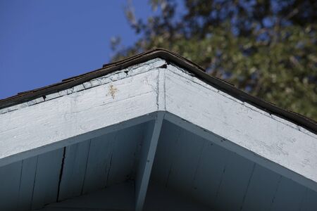 Close up of white trimmed awning on a blue house