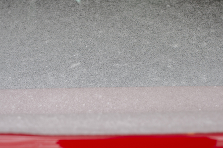 Snow and ice covering the back windshield of a vehicleの写真素材