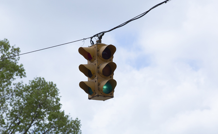 Green traffic light signaling for traffic to continue through the lightの写真素材