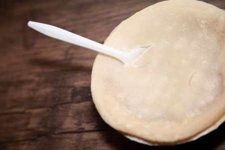 Spoon in a chicken pot pie on a wooden tableの写真素材