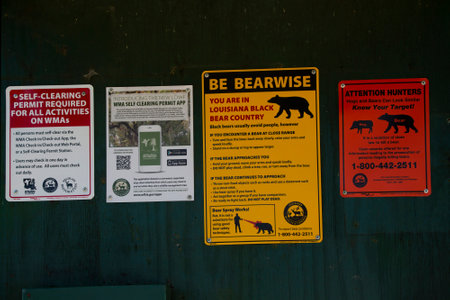 RUSSELL SAGE WILDLIFE MANAGEMENT AREA LOUISIANA/USA â FEBRUARY 24 2020: Louisiana Wildlife and Fisheries signs giving tips on safety during bear encounters, differentiating a bear from a wild hog, and completing self-clearing permits for access to Louisのeditorial素材