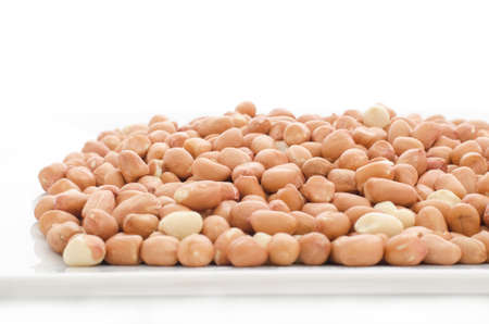 Peeled peanuts on white plate