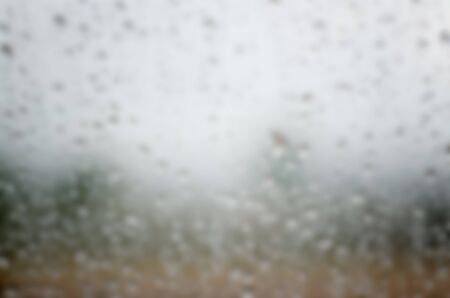 Blurred water drops on window glass, designed for adding text overlays and any creative ideas.の写真素材
