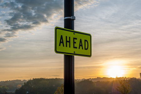 "Ahead" Street sign with sunrise background. Inspirational image. Motivational image. Sunrise Sunset cloud background. Beautiful Sky background.Minimal art and design. Morning sun. Artistic backgroundの写真素材