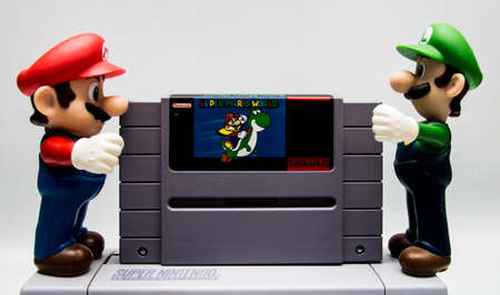 Mario and Luigi putting Super Mario World in a SNES