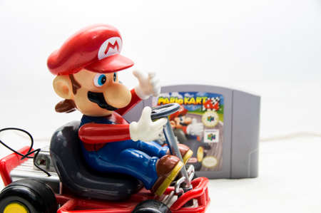 Mario Kart toy beside a Mario Kart 64 Game
