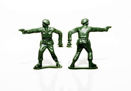 Two plastic green soldiers standing beside each other