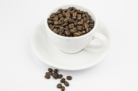 White cup with coffee beansの写真素材