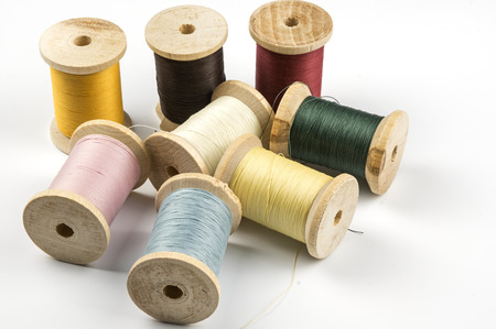 Wooden spools with sewing thread
