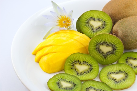 Kiwi and mango fruit with  lotus flower on white backgroundの写真素材