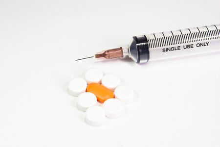 pills with syringes on white backgroundの写真素材