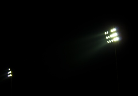 Stadium floodlights on a sports field at nightの写真素材