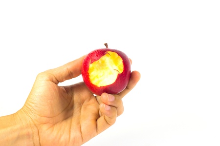 bitten apple in hand, isolated on white backgroundの写真素材