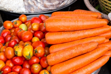 fresh carrot with tomato in the marketの写真素材