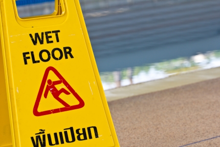 Sign advising caution on wet floorの写真素材
