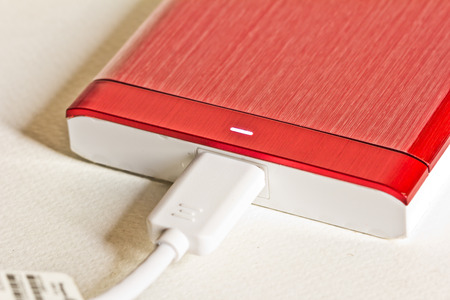 Red portable drive on white background