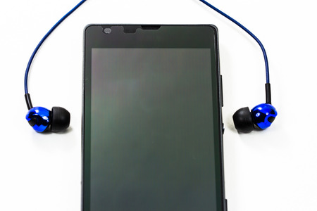 earphone with smart phone on white の写真素材