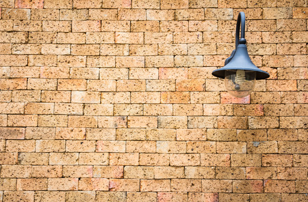 Lamp on red brick wall texture backgroundの写真素材