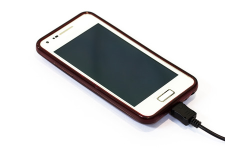 Charging mobile phone isolated on white background