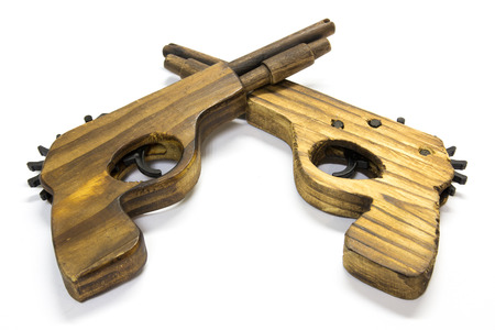 Toy wooden gun  on a white backgroundの写真素材