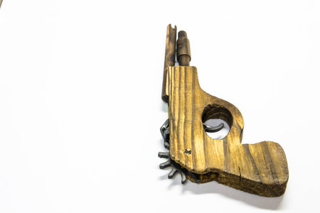 Toy wooden gun  on a white backgroundの写真素材