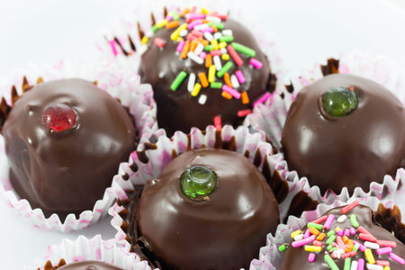 Close up chocolate ball with topping in paper cup