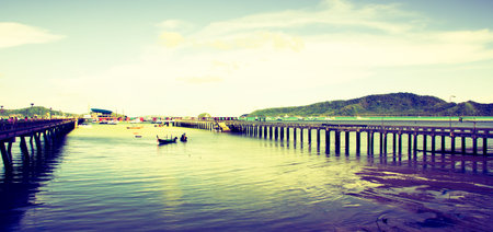 Harbour with fishing boats vintage style ship and docks in Phuket Thailandの写真素材