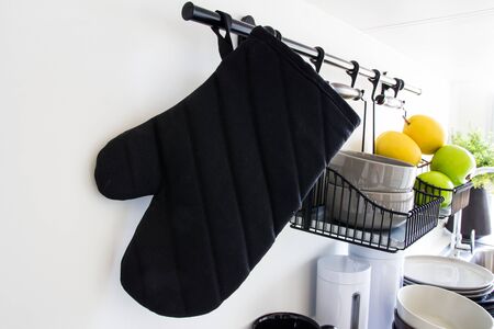 kitchen glove hung on wall surfaceの写真素材