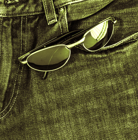 vintage sunglasses on jeans textureの写真素材