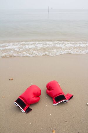 red boxing glove on the beachの写真素材