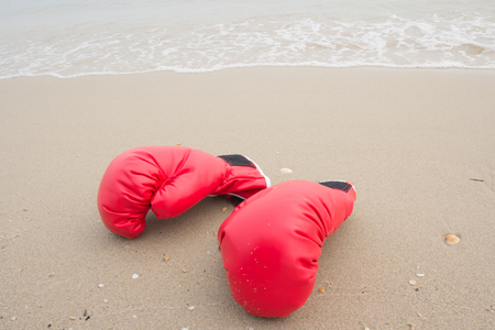 red boxing glove on the beachの写真素材