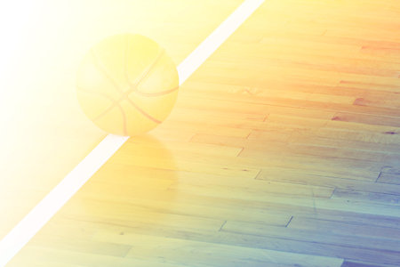 Basketball ball over floor in the gym with color filtersの写真素材