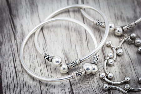 Silver bracelet on wooden background