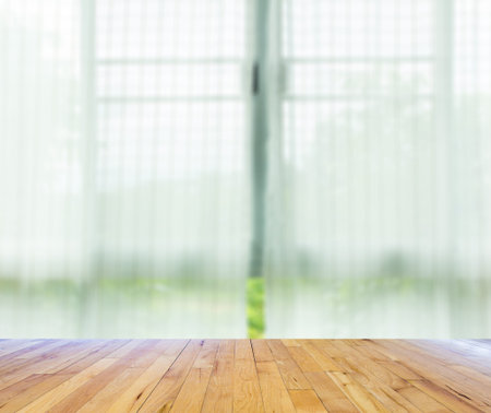 Blurred curtain on the window with wooden floorの写真素材