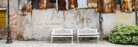 street wall background with white chairの写真素材
