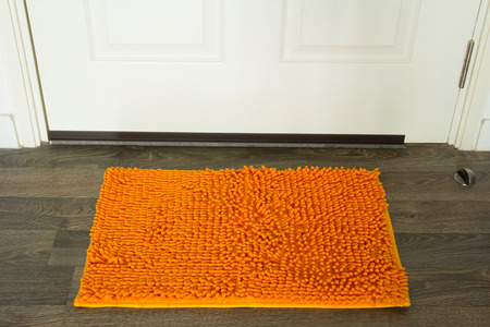 Door mat on front doorの写真素材