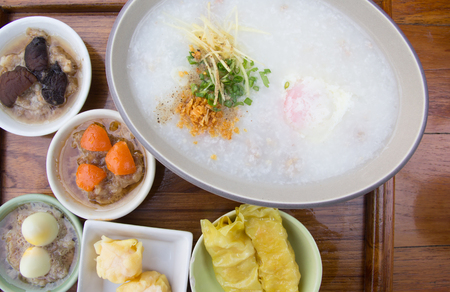 Porridge with dim sum on plateの写真素材