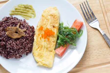 Rice with omelette on plateの写真素材