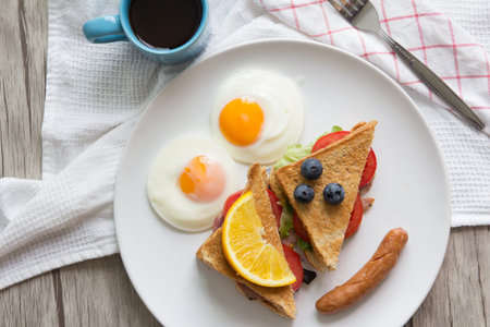 Sandwich with ham and tomatoes on plate