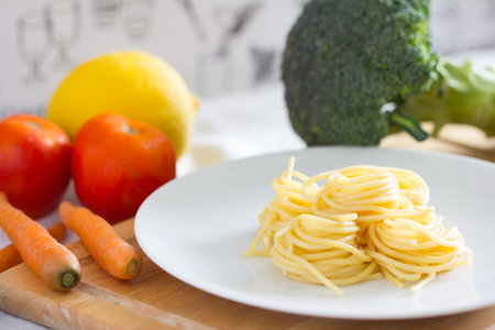 Spaghetti with fish and pesto sauce on white plate. Traditional italian cuisine.