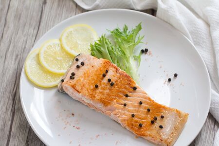 Grilled salmon steak with lemon and herb.の写真素材