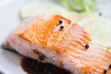 Grilled salmon steak with lemon and herb.の写真素材