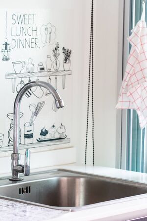 Water tap with sink in modern kitchen.の写真素材
