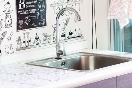 Water tap with sink in modern kitchen.の写真素材